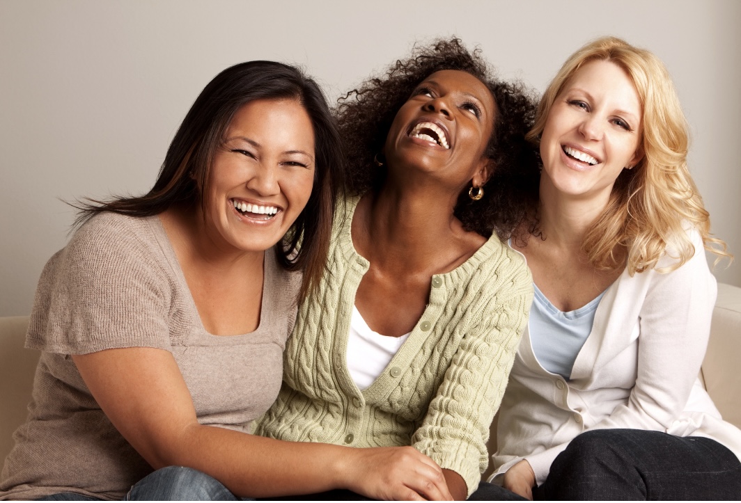 3 women sitting together and laughing